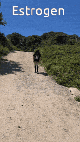 a woman is walking up a dirt road with the word estrogen written above her