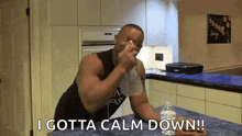 a man is sitting at a kitchen counter drinking water from a bottle .