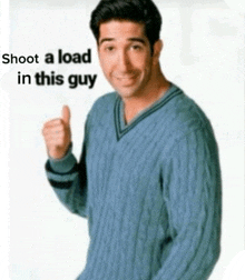 a man in a blue sweater is giving a thumbs up with the words shoot a load in this guy above him