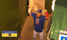 a man wearing a chicago cubs jersey is walking down stairs