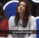 a woman wearing headphones is sitting in front of a microphone with the caption so annoyed and bored
