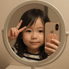 a little girl is taking a selfie with her phone