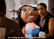 a woman is holding a stuffed doll and asking am i losing my mind or did we not return this ?
