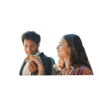 a man and a woman are looking at something