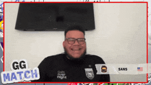 a man wearing glasses and a shirt that says gg match is smiling
