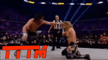 a man in a wrestling ring with a full aew banner behind him