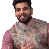 a man with a beard is wearing a pink shirt with a paisley vest