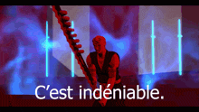 a man holding a sword with the words " c'est indeniable " above him