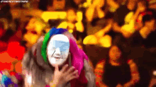 a colorful painting of a woman with a mask on her face .