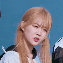 a close up of a girl with blonde hair making a face