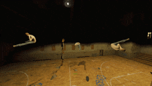 a basketball court with a few people doing tricks and a few letters written on the floor