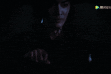 a man with long hair wearing a hat and holding a sword with chinese writing on the screen