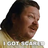 a man with a tattoo on his neck has the words " i got scared " on his face