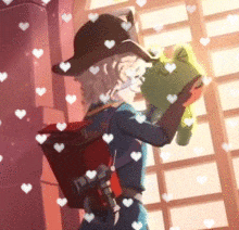a girl in a hat is holding a green frog .