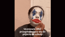 a person with a clown face painted on their face and the words uczniowie onz