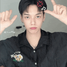 a man wearing a black shirt with a flower on it
