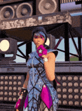a woman in a blue and pink outfit is standing in front of speakers and lights