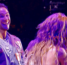 a man and a woman are laughing in front of a purple background with the hashtag mafia rbdgif
