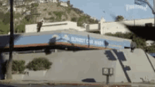 a skateboarder is doing a trick on the roof of a building that says transit on it