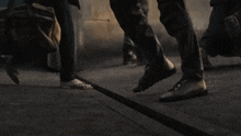 a group of people are walking down a street and one of them is barefoot