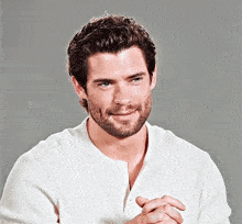 a man with a beard wearing a white shirt