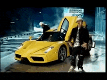 a man standing next to a yellow sports car with the hood open