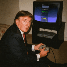a man in a suit and tie is playing a video game in front of a toshiba tv