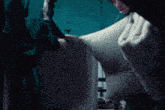 a person is holding a white pillow in their hands