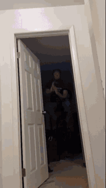 a man taking a picture of himself in an open door