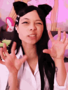 a woman wearing cat ears and a white shirt