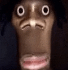 a close up of a person 's face with big eyes and a pink lip .