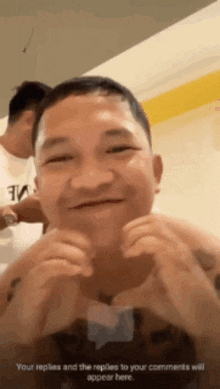 a man is making a funny face with his hands on his face