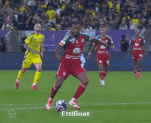 a soccer player wearing a jersey with the number 21 on it is kicking the ball