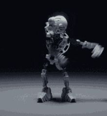 a robot is dancing in a dark room .
