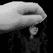 a black and white pixel art of a hand holding a woman 's face .