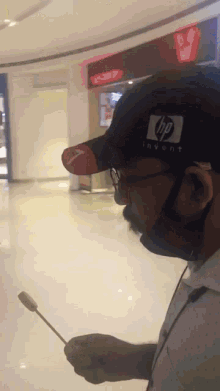 a man wearing a black hat with the hp logo on it