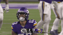 a football player wearing a purple helmet with the number 13 on the front