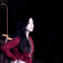 a blurry picture of a woman in a red shirt in the dark
