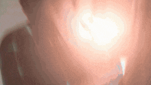 a blurred image of a person 's face with a light coming out of their mouth