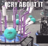 a green ball with the word first on it is sitting on top of a purple rack .