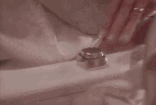 a woman with red nails is adjusting a faucet on a toilet
