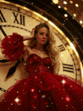 a woman in a red dress stands in front of a clock with roman numerals xii on it