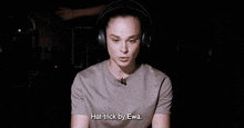 a woman wearing headphones is saying " hat-trick by ewa "