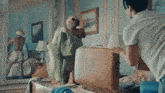 a man is standing next to a suitcase in a bedroom .