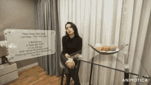 a woman is sitting at a table with a sign that says floor area 500 sqm