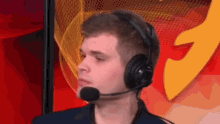 a man wearing headphones and a microphone looks to his left