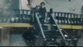 a man is standing on a set of stairs next to a train .
