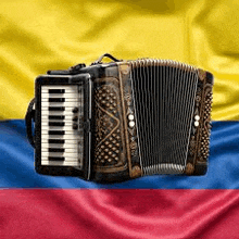 an accordion is sitting in front of a flag of colombia .
