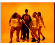 a man wearing a shirt with the number 05 on it is surrounded by women