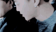 a close up of a person 's face with a man behind her .